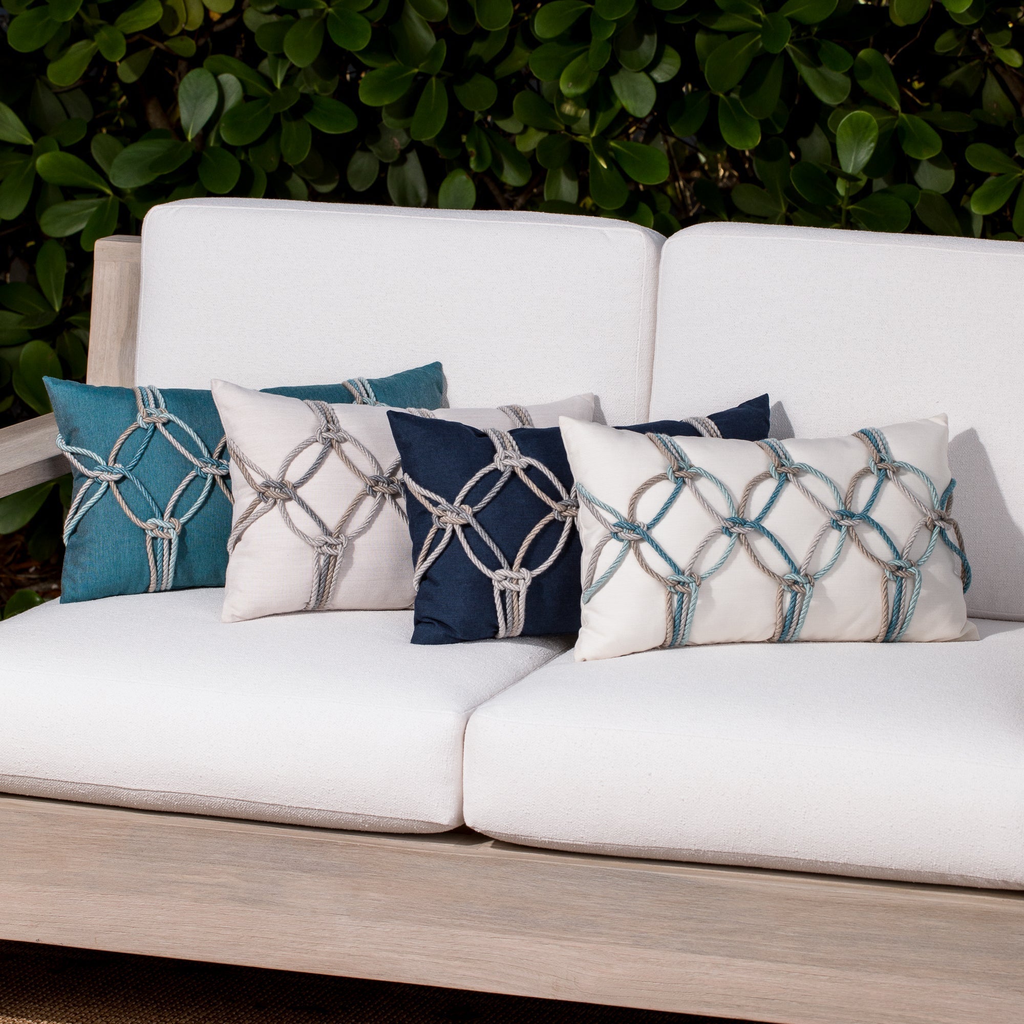 multicolored pillows with hand embelished rope design, safe for outdoor use by Elaine Smith