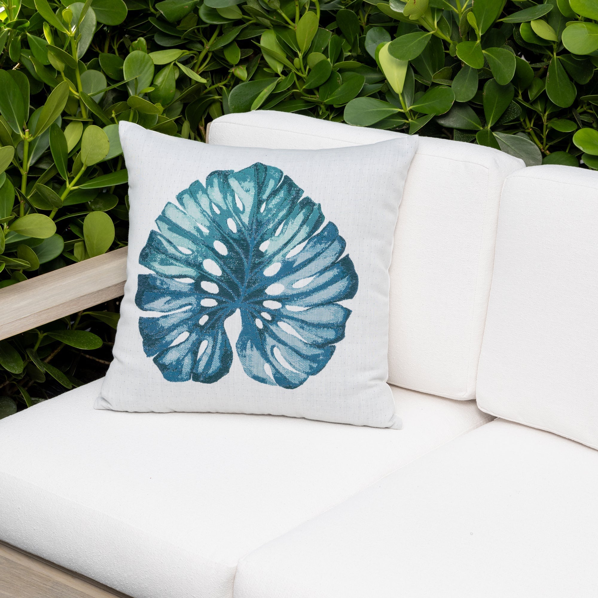 Outdoor image of leaf lagoon and stripe pillows on outdoor sofa