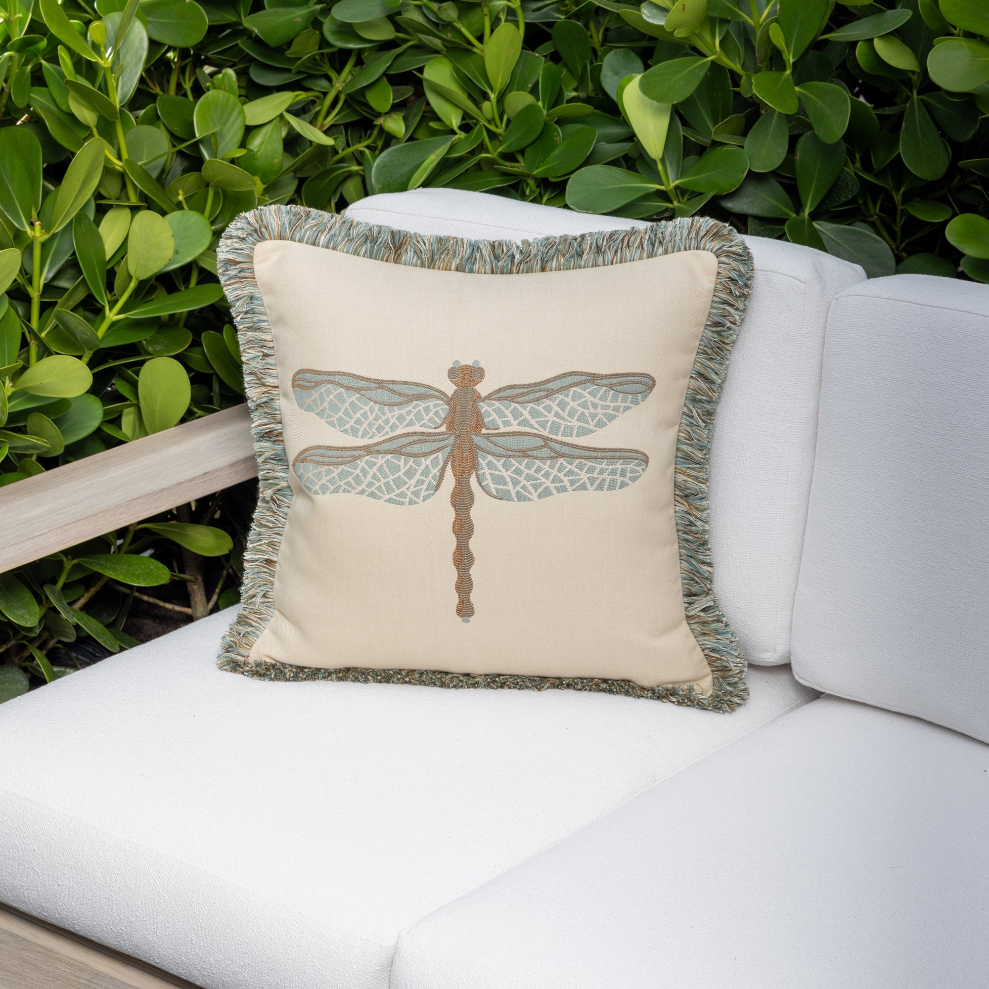Luxury dragonfly woven throw pillow on a outdoor sofa, featuring UV and fade resistant fabric to complete indoor and outdoor decor