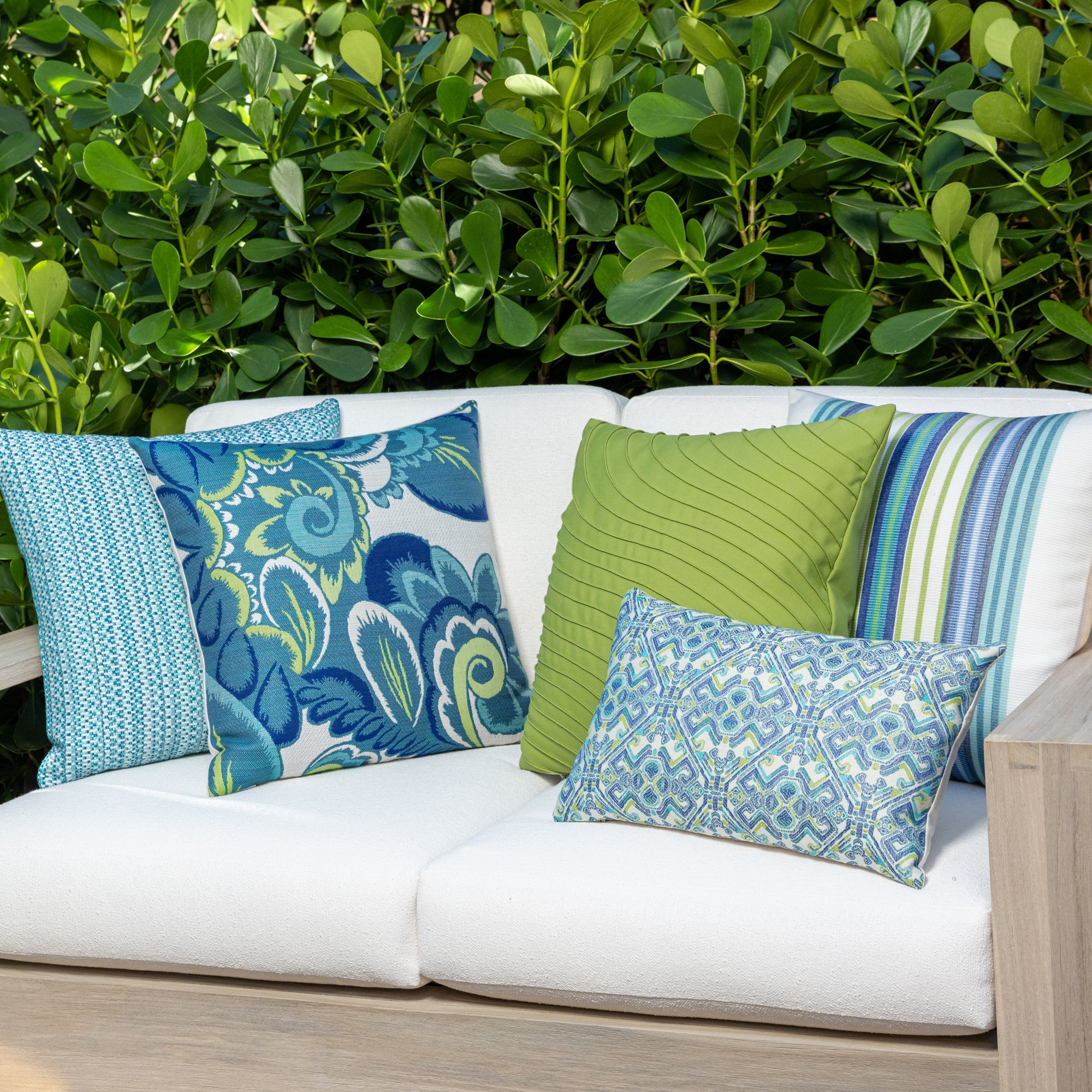 Outdoor image of pillows in Bright ginkgo green outdoor-safe canvas woven fabric