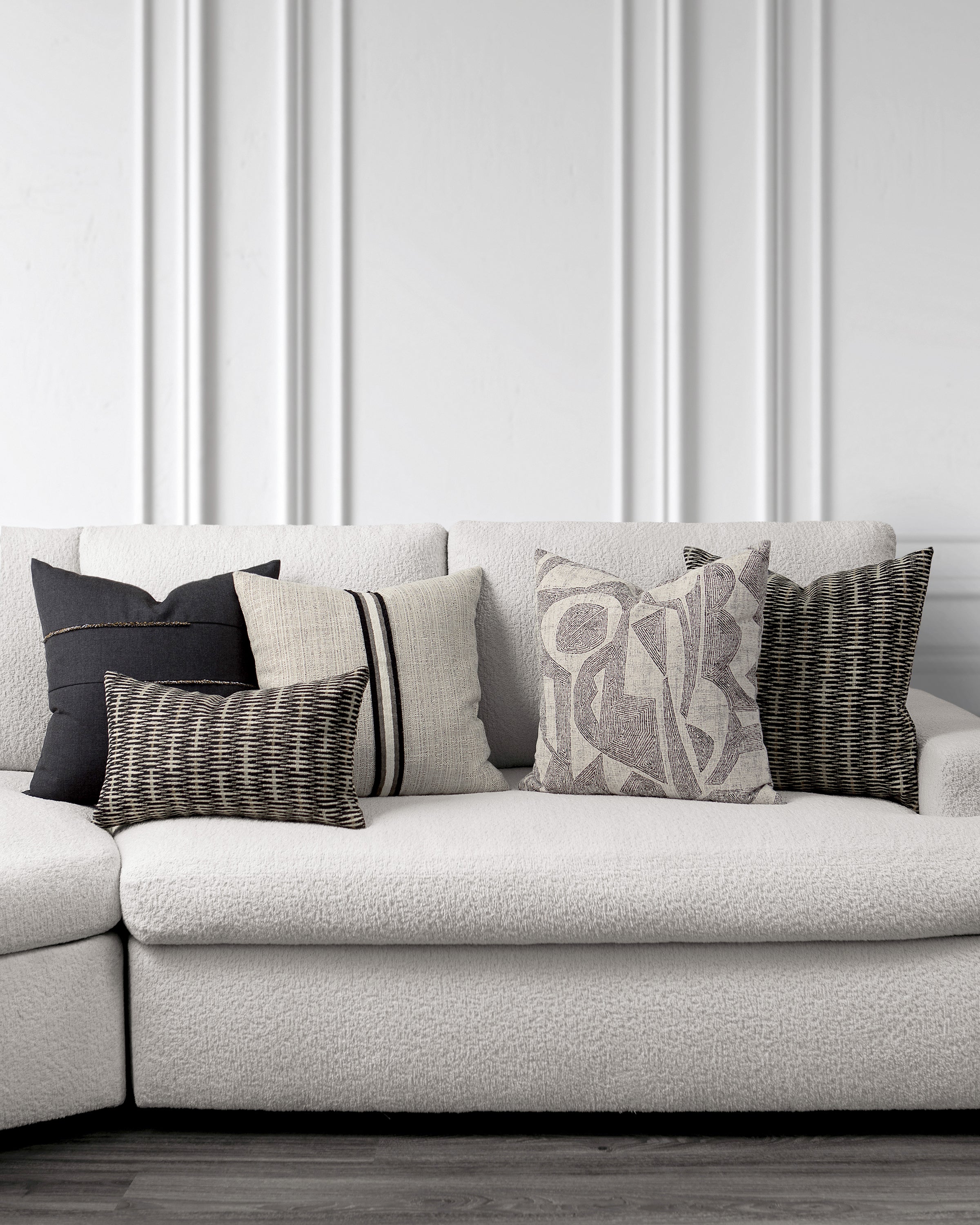 indoor environmental image of ebony and beige coordinated pillow group by Elaine 