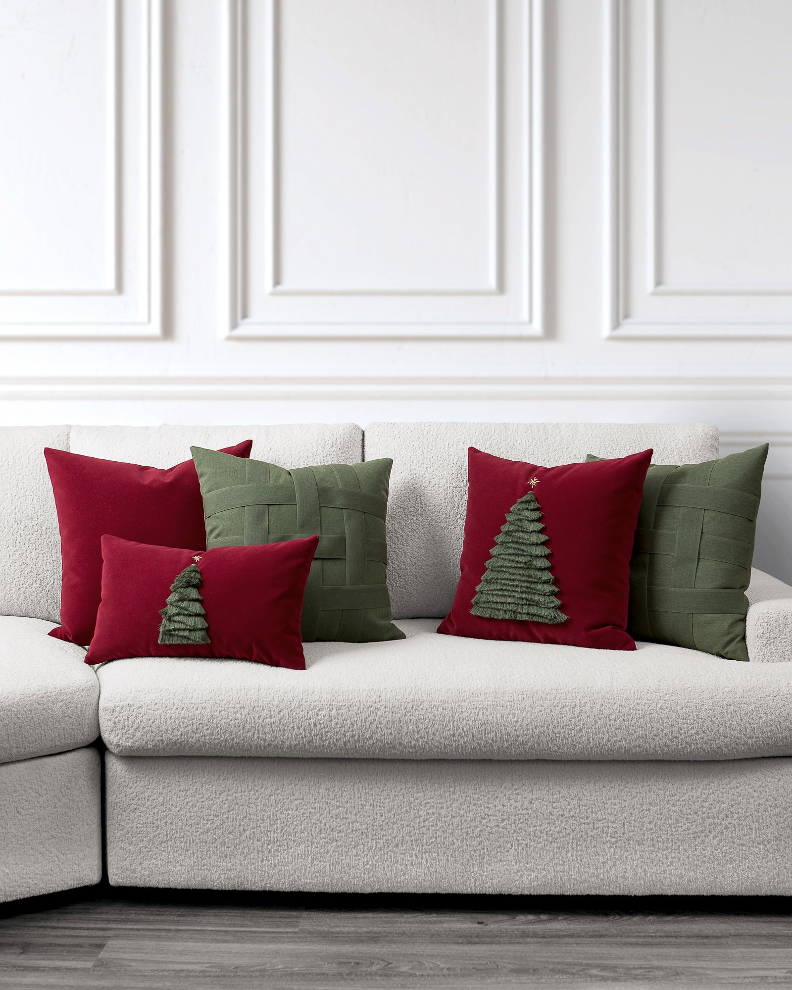 indoor environmental image of red and green evergreen holiday pillow group by Elaine Smith