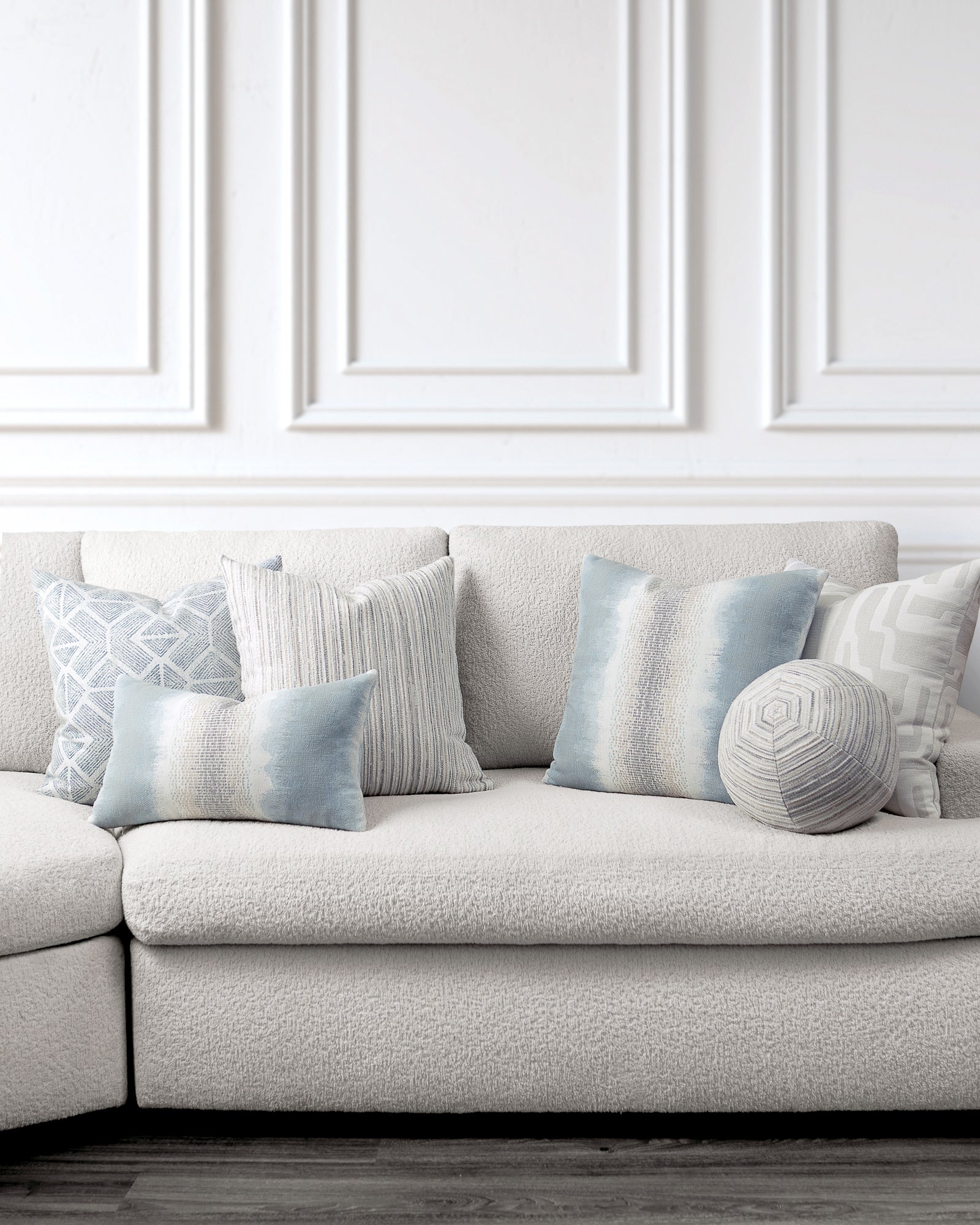 indoor environmental image of sky blue white and gray coordinated pillow group by Elaine 