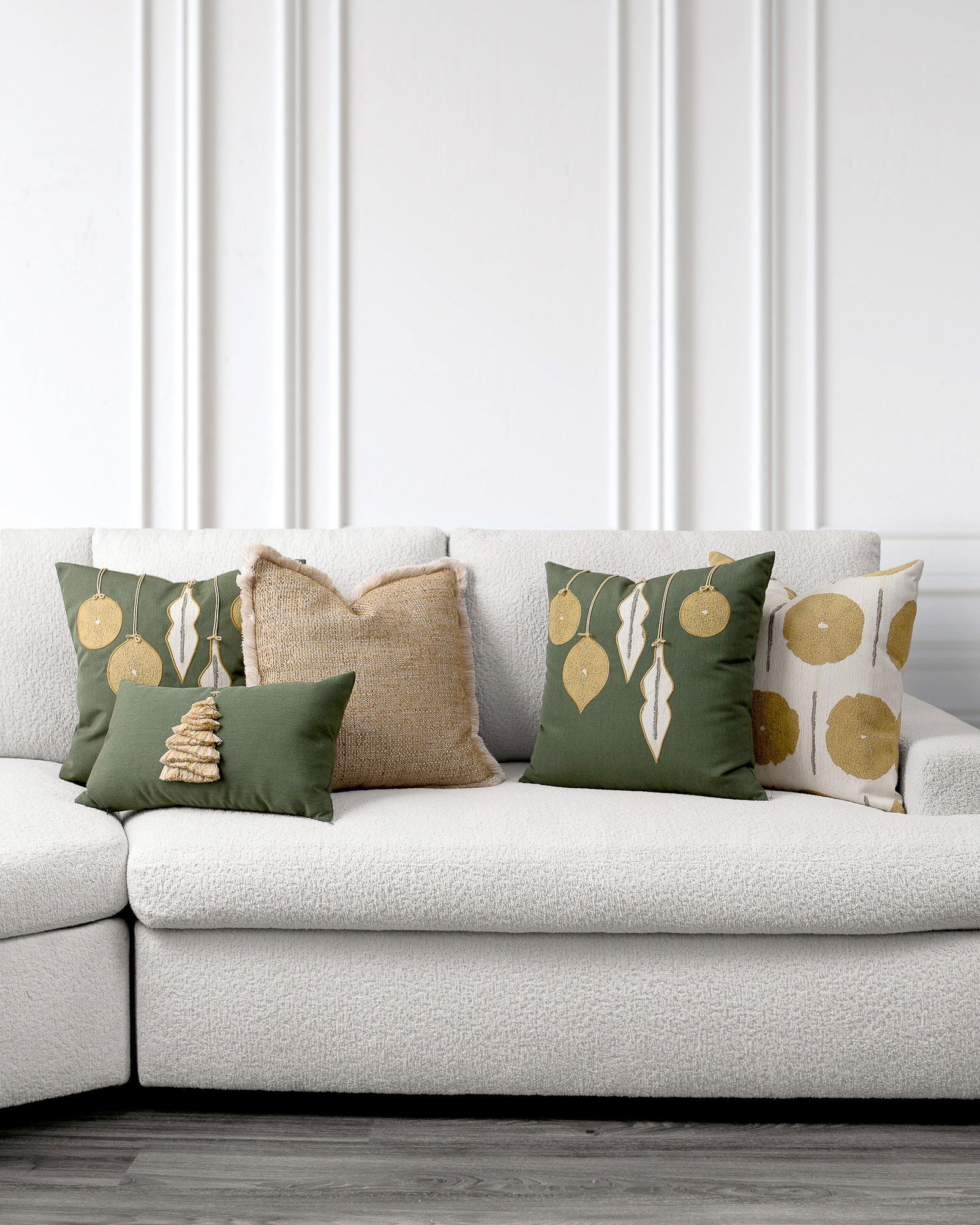 indoor environmental image of green and gold spruce holiday pillow group by Elaine Smith