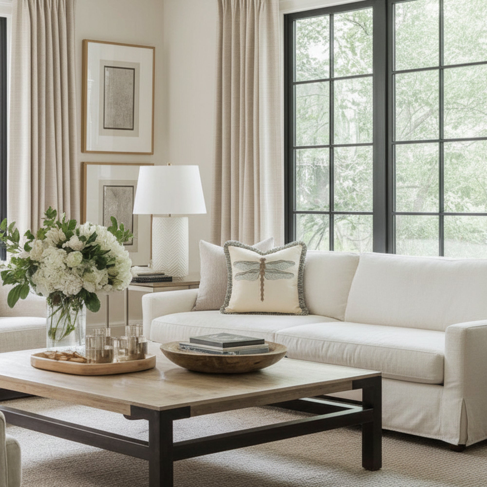 dragonfly woven pillow with fringe on ivory sofa
