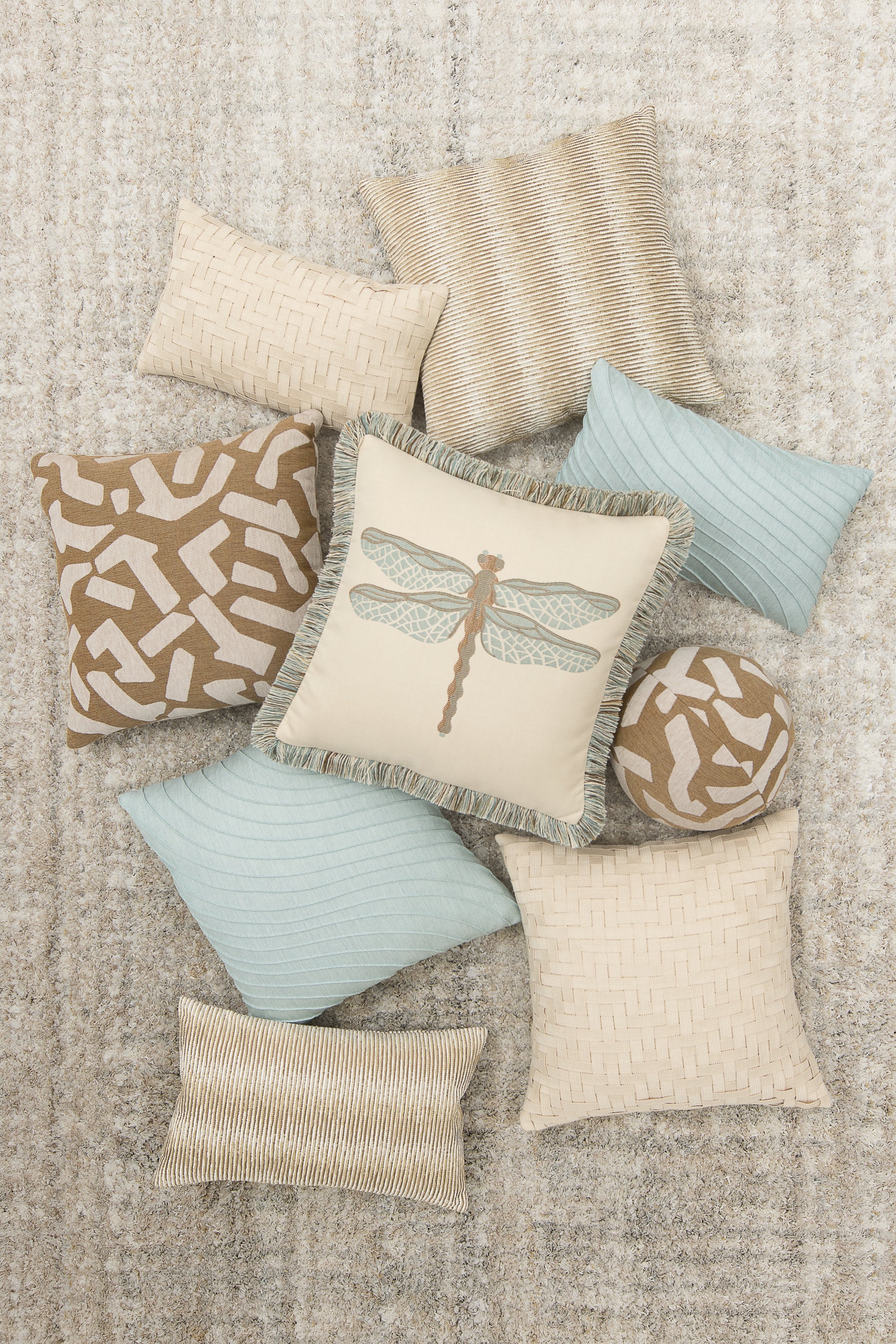 Collection of decorative pillows with various patterns on a textured surface- outdoor safe by Elaine Smith
