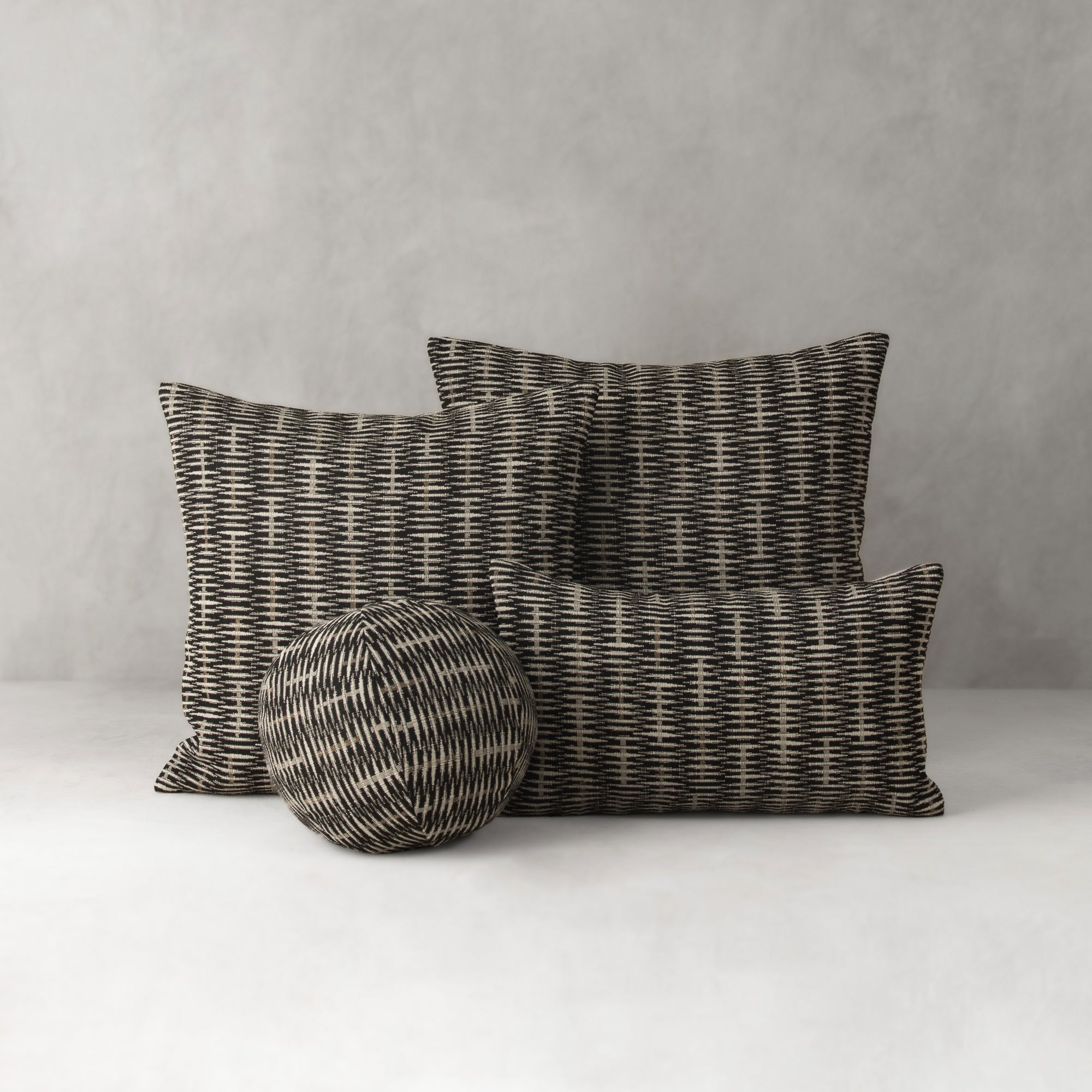 Textured pillows and a ball on a neutral background