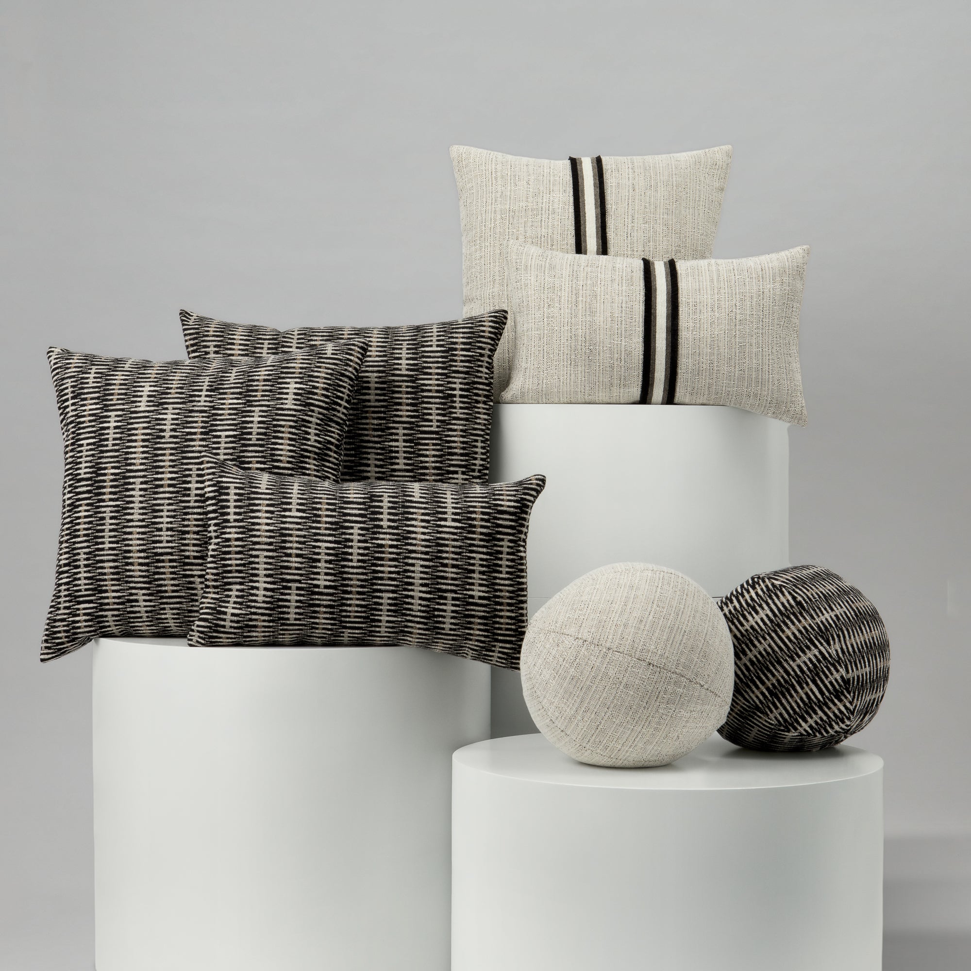 Decorative pillows and spherical objects on a gray background