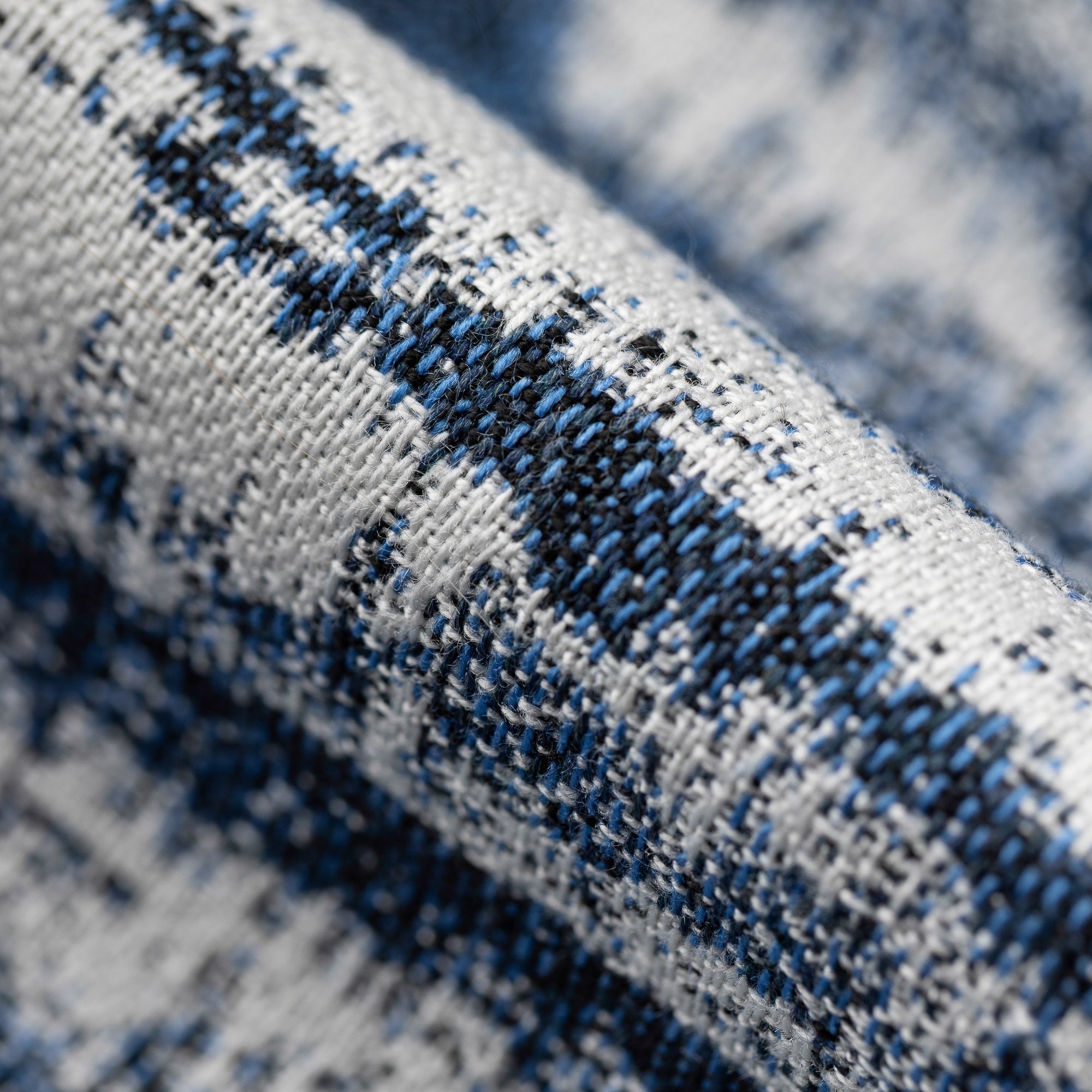 Close-up of a textured fabric with blue and black pattern