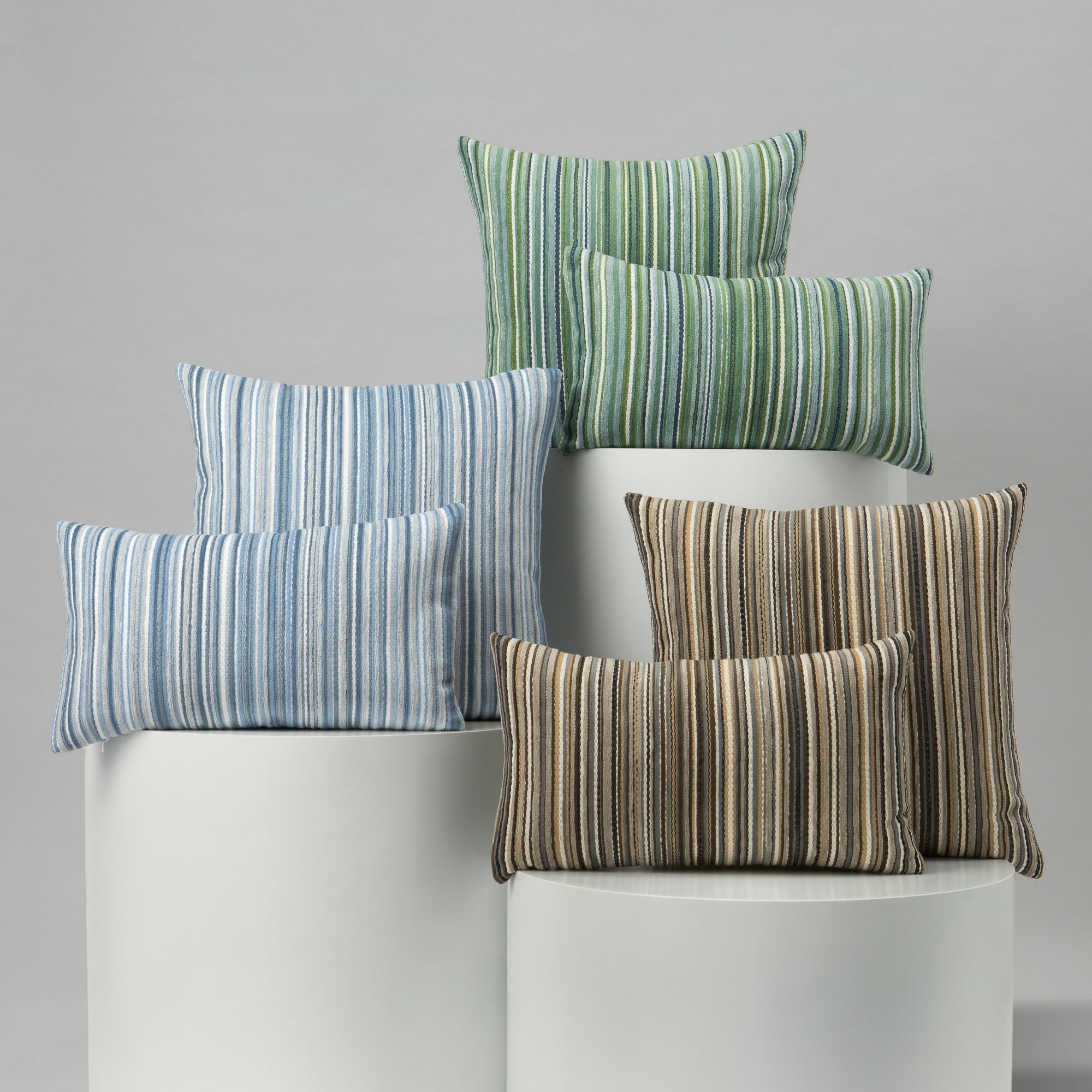 Set of striped pillows in various colors on a gray background