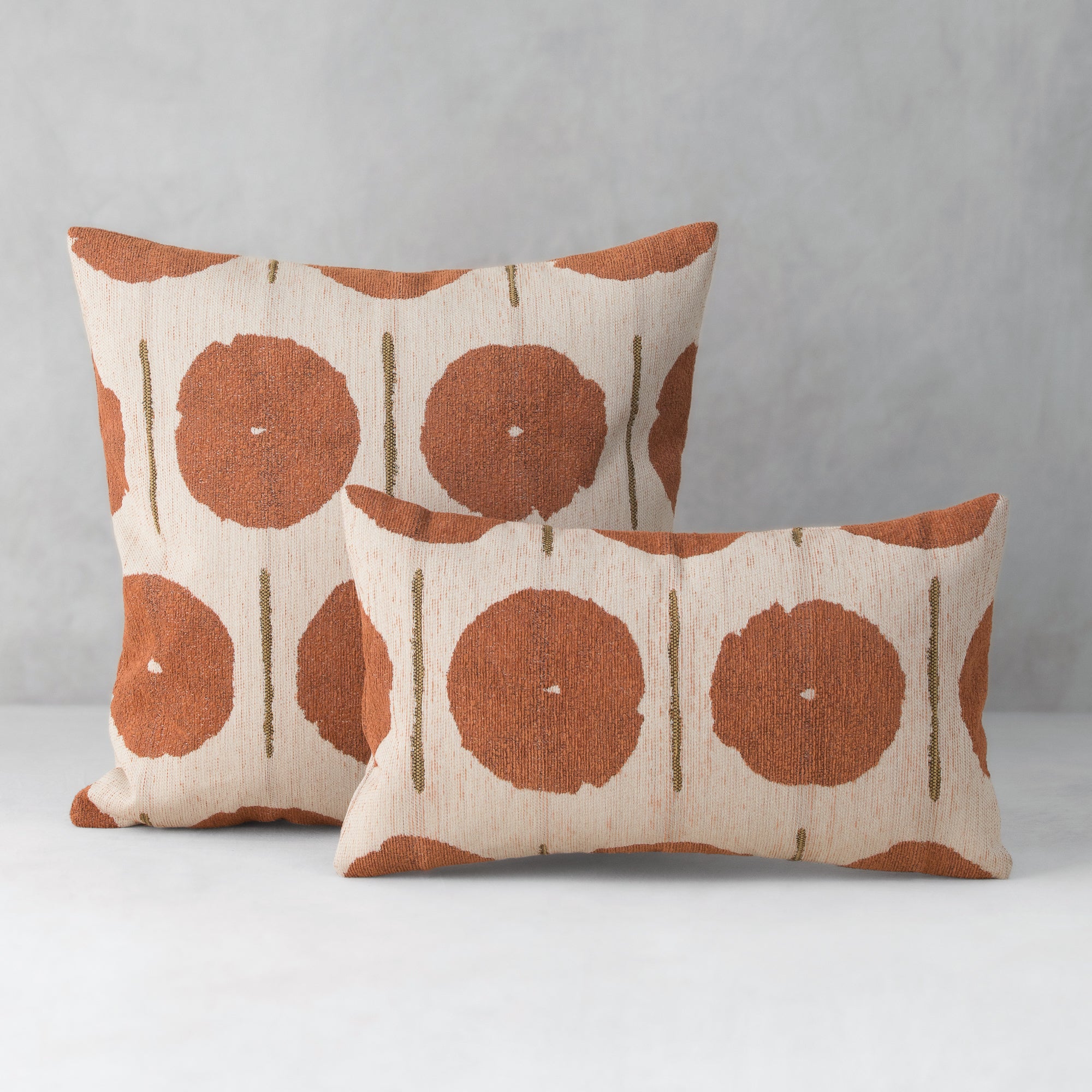 Two patterned pillows on a gray background