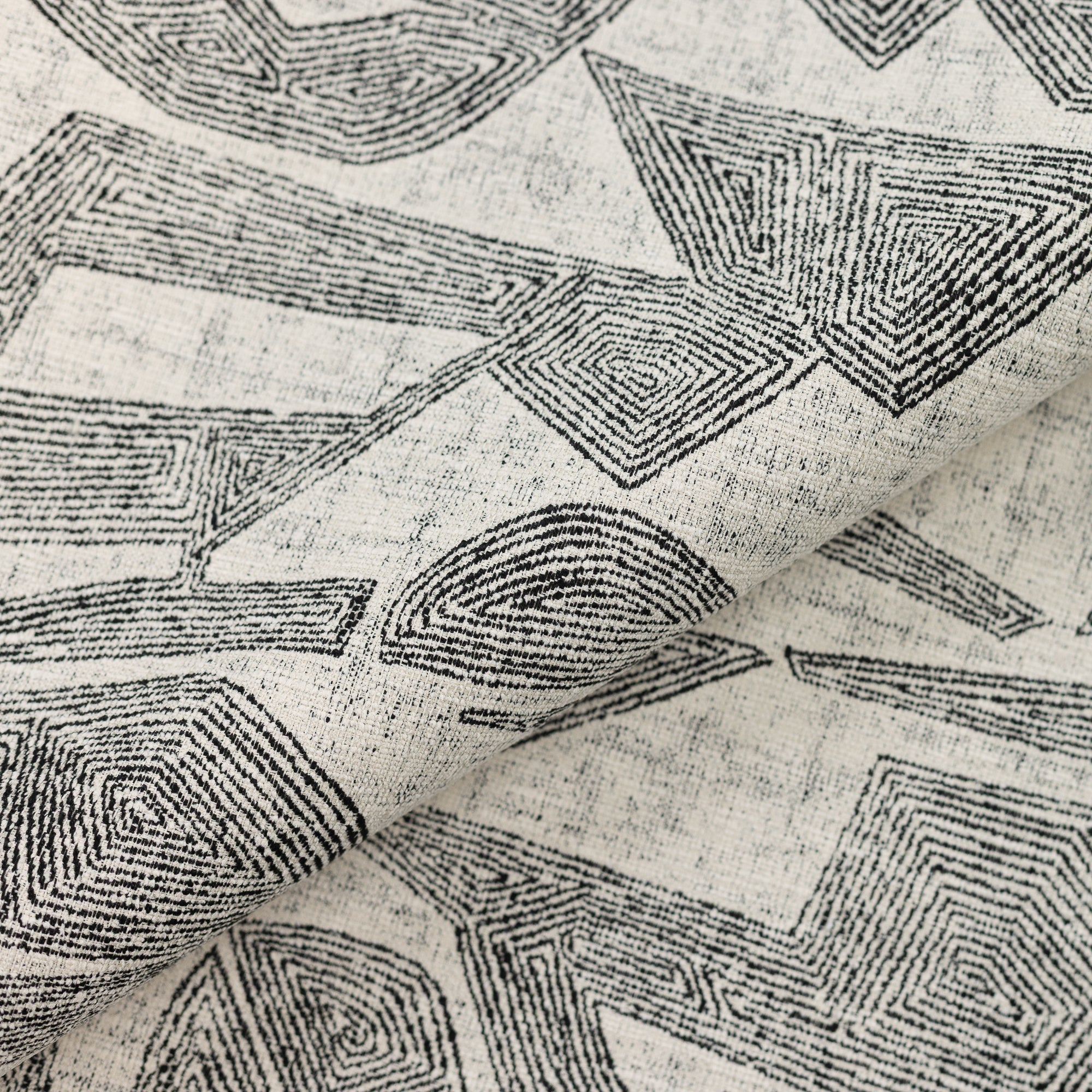 Close shot texture image of Ebony-toned geometric outdoor safe fabric with tribal-inspired design