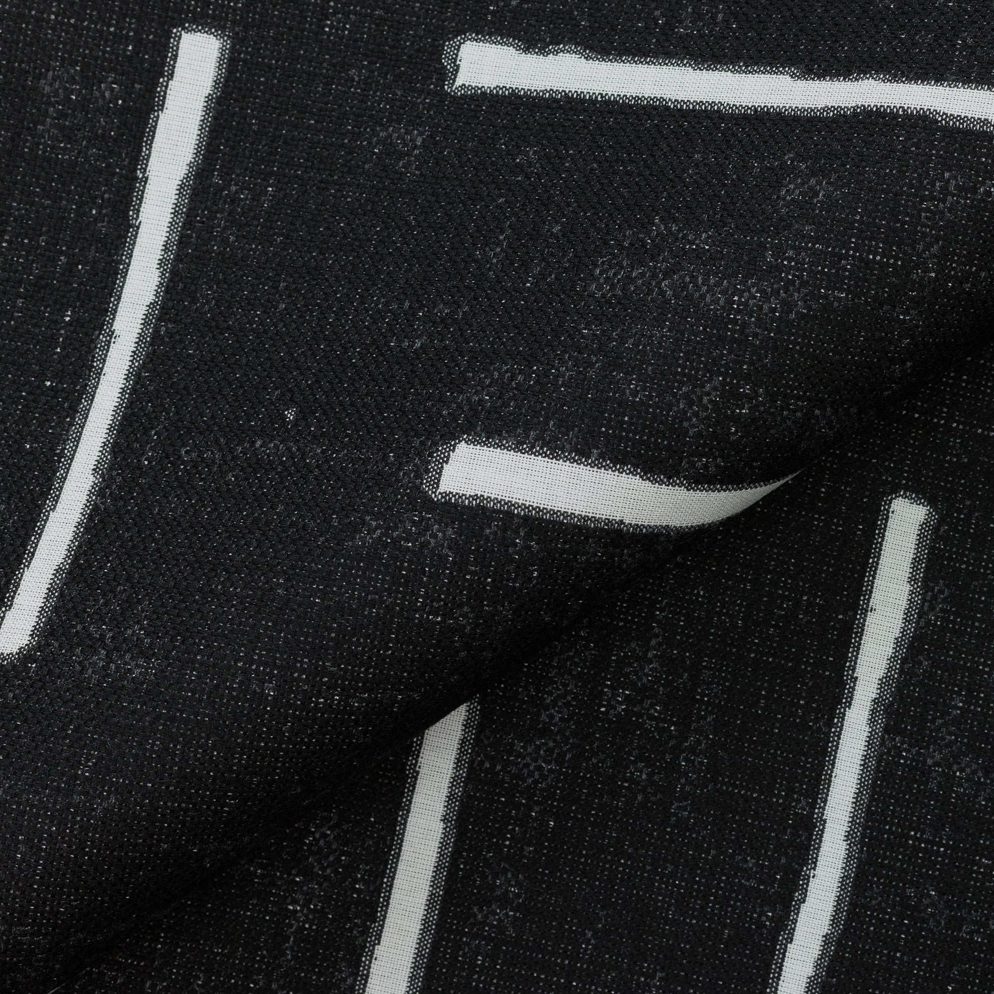 Close shot texture image of Ebony black outdoor safe woven fabric with abstract linear pattern – Instinct Ebony by Elaine Smith
