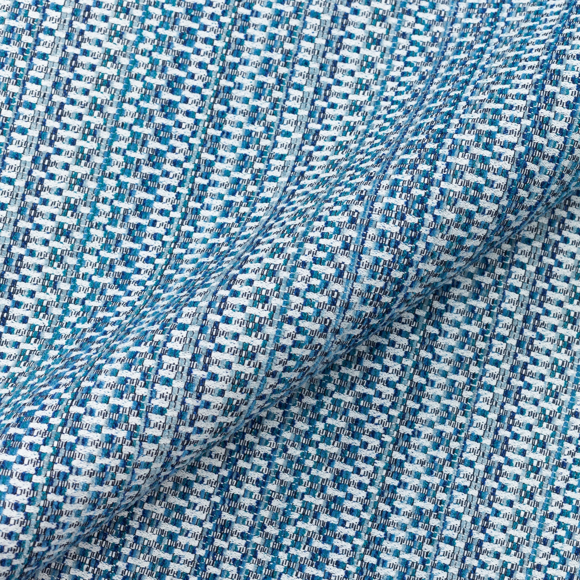 Close shot texture image of Indigo-colored multi-colored chenille kaleidoscope design in performance outdoor safe fabric