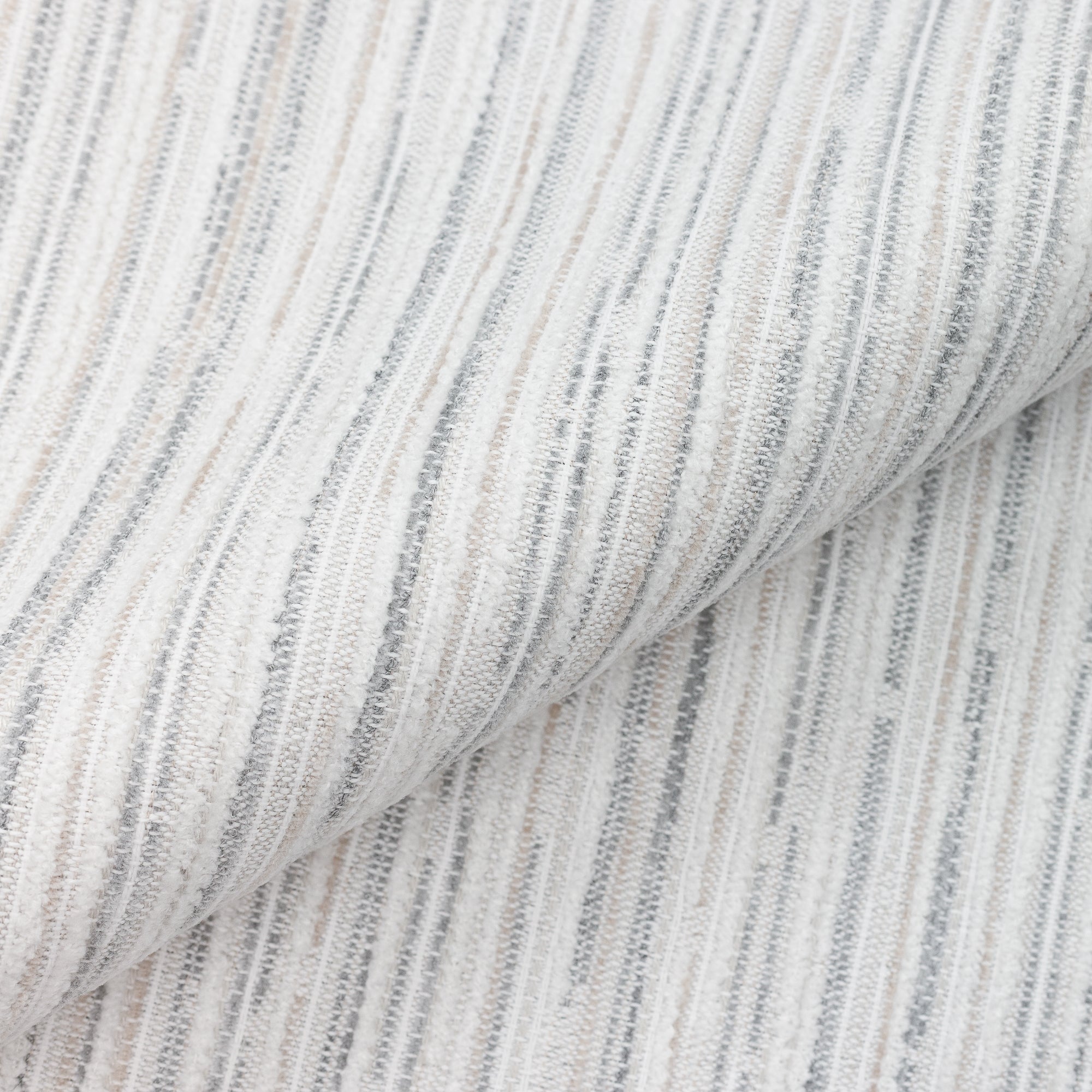 Close shot texture image of Outdoor-safe fabric with narrow vertical stripes in soft pebble hues of soft chenille