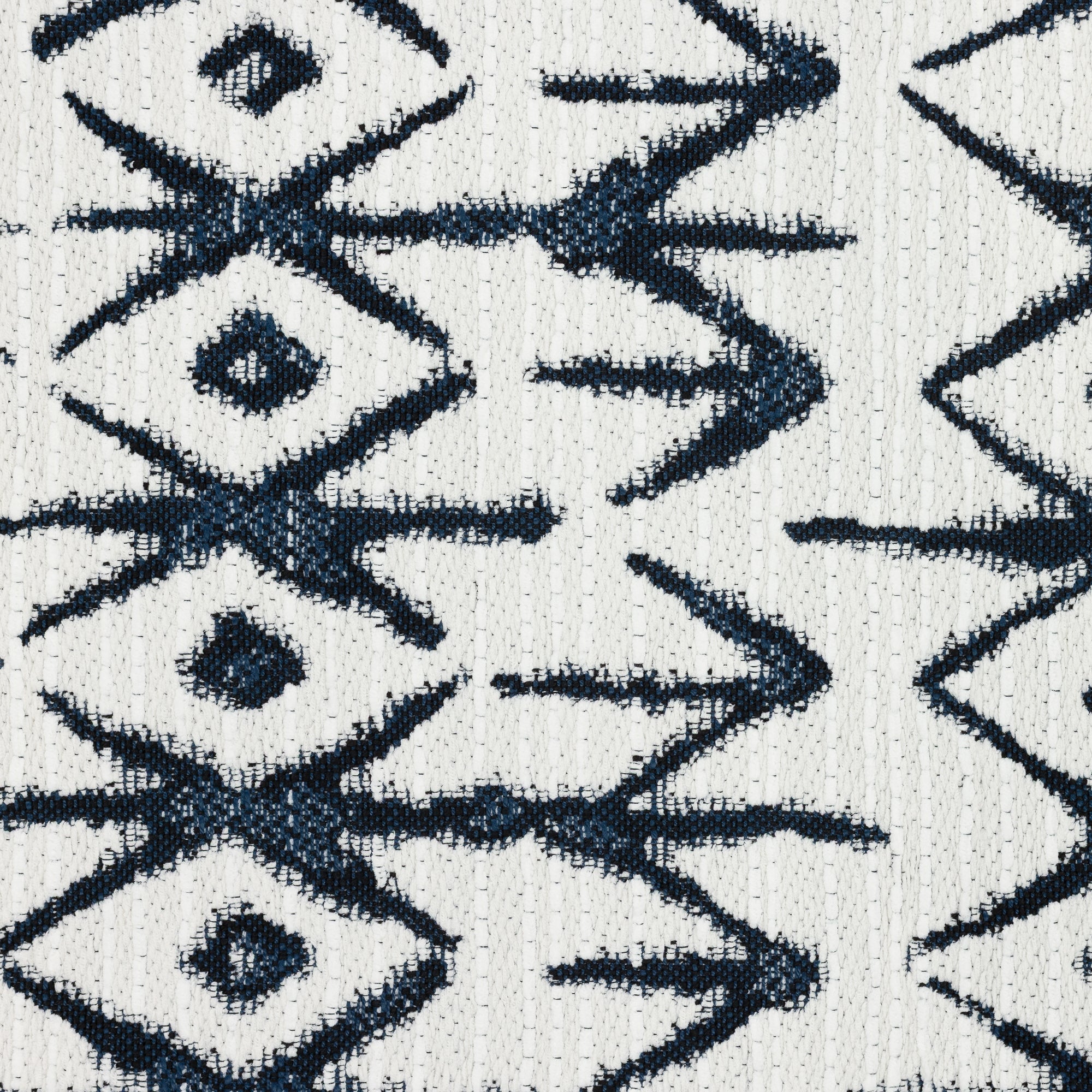 Detail image of Tribal-inspired indigo and white patterned outdoor safe woven fabric