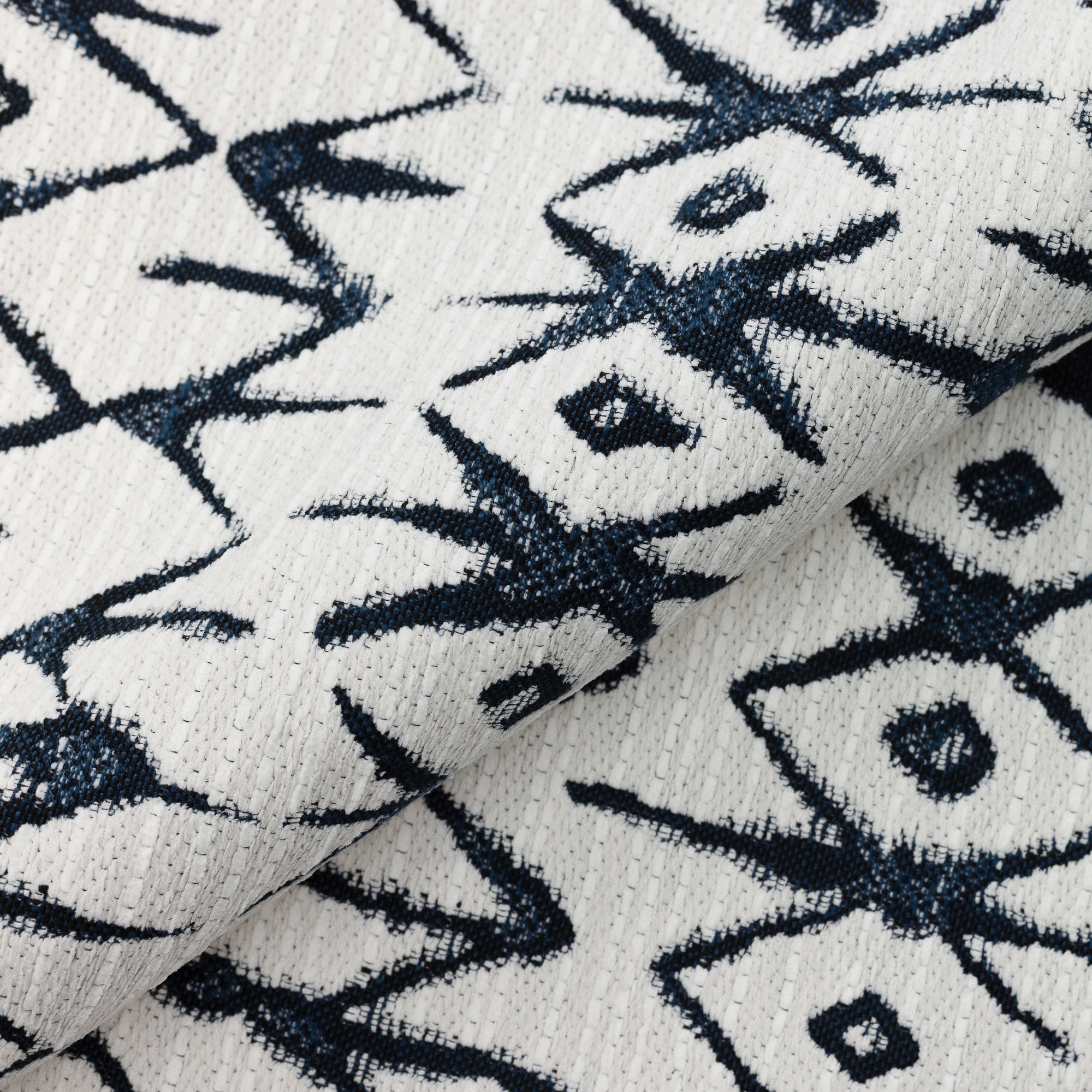 Close shot texture image of Tribal-inspired indigo and white patterned outdoor safe woven fabric
