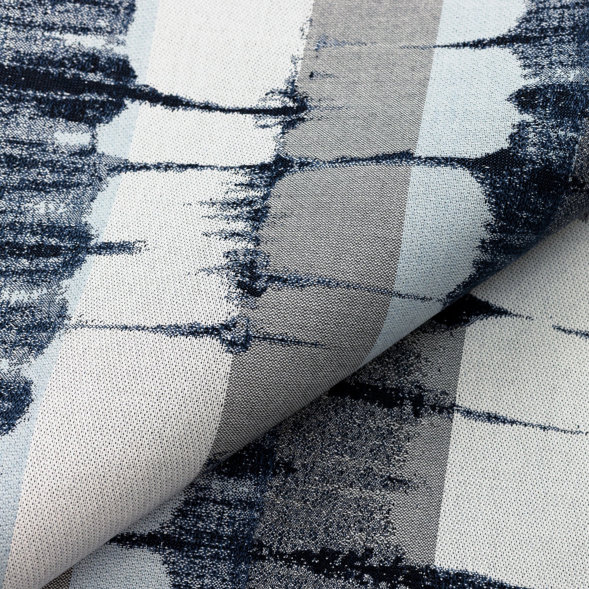 Close shot texture image of Artistic outdoor-safe fabric featuring a hand-dyed Shibori indigo pattern