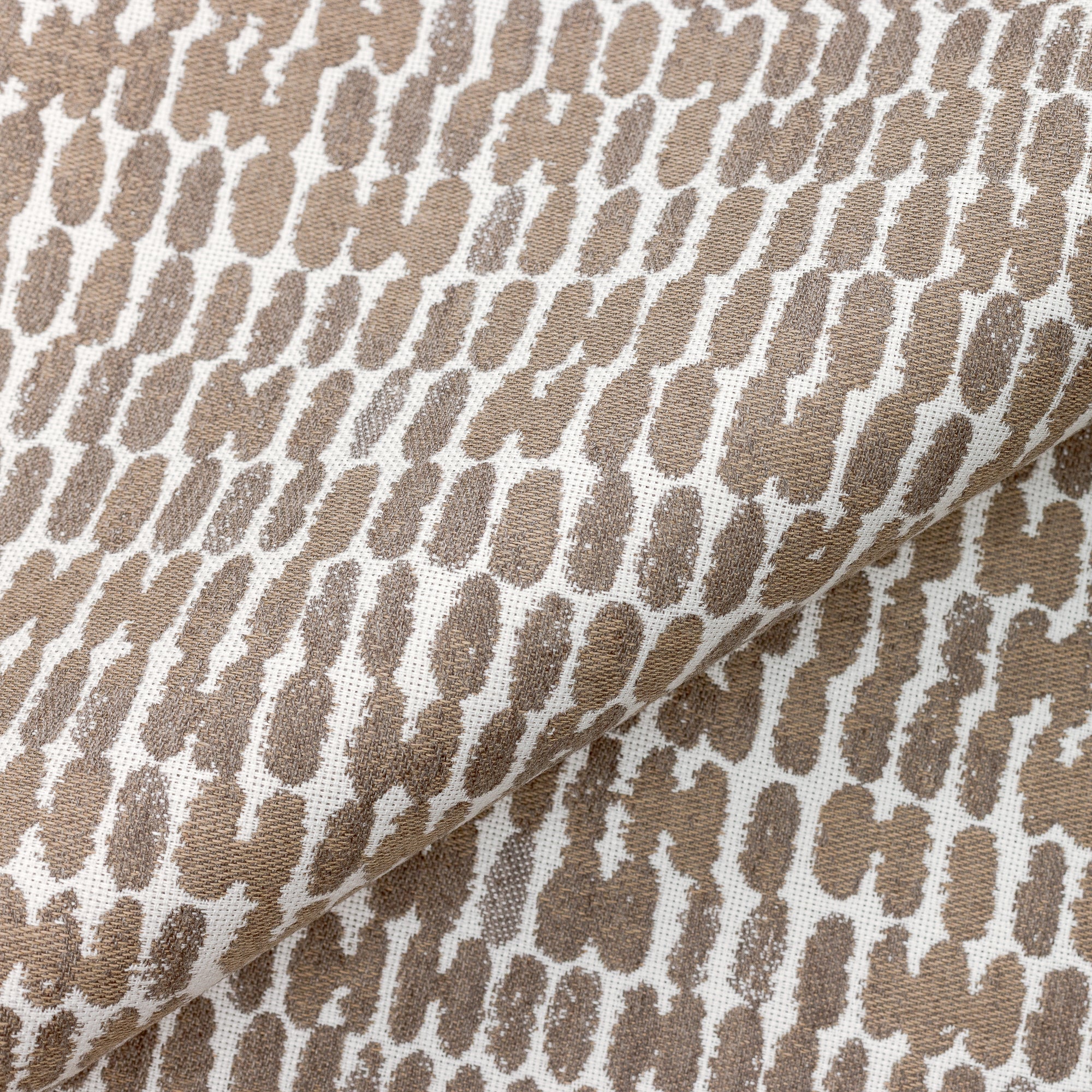 Close shot texture image of Thumbprint Latte – outdoor-safe woven fabric by Elaine Smith, ideal for high-end commercial and residential applications.