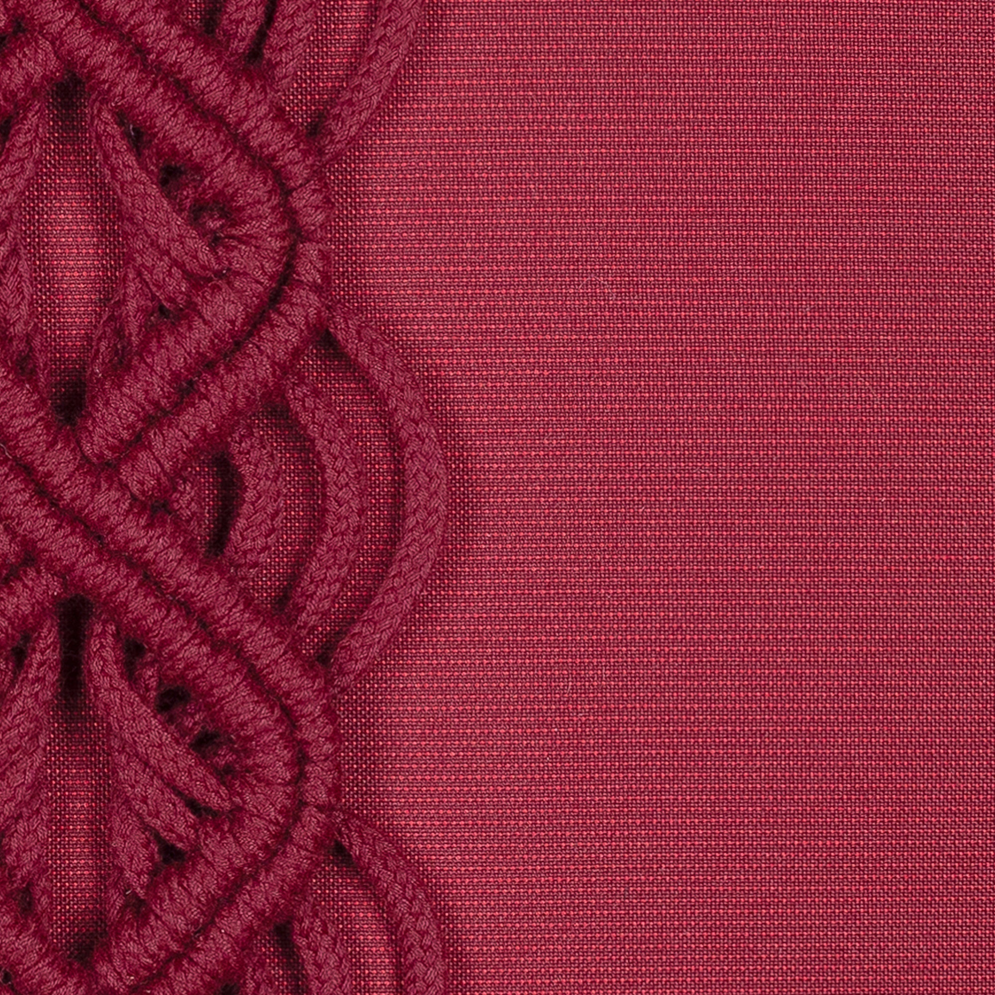 Detail image of Red outdoor pillow with solid texture, lumbar size for vibrant holiday accents